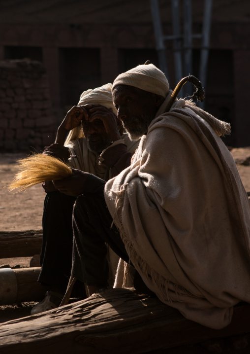 Old men with flyswatters during kidane mehret orthodox celebration, Amhara region, Lalibela, Ethiopia