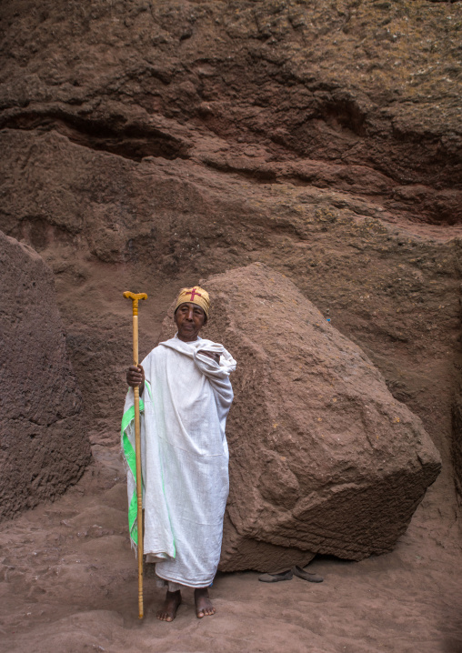 Lonely ethiopian woman monk in a rock church during kidane mehret orthodox celebration, Amhara region, Lalibela, Ethiopia