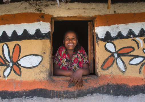 Ethiopia, Kembata, Alaba Kuito, ethiopian woman standing in the window of her traditional painted house