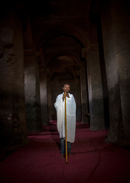 Ethiopian priest in the middle of medhane alem rock church 
, Amhara region, Lalibela, Ethiopia