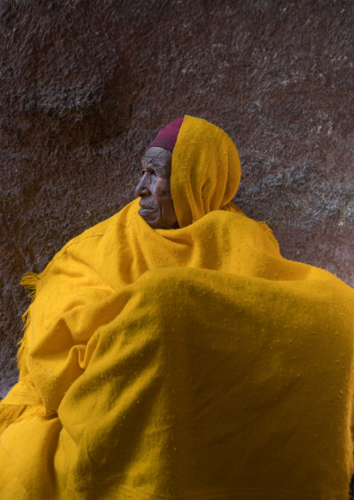 Portrait of a monk woman in yellow shawl during kidane mehret celebration, Amhara region, Lalibela, Ethiopia