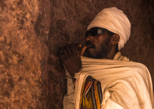 Blind priest praying during kidane mehret orthodox celebration, Amhara region, Lalibela, Ethiopia
