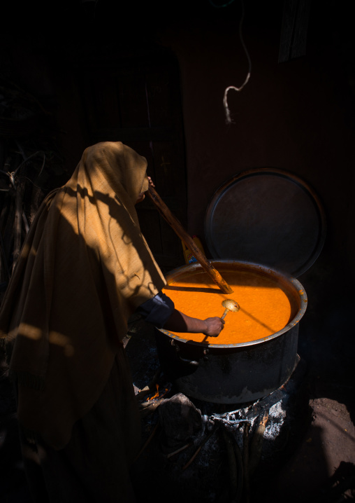 Woman cooking churro during kidane mehret orthodox celebration, Amhara region, Lalibela, Ethiopia