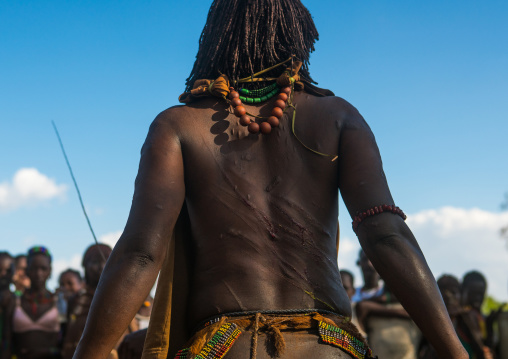 Hamer tribe woman waiting to be whipped during a bull jumping ceremony, Omo valley, Turmi, Ethiopia