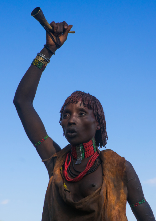 Hamer tribe woman dancing during a bull jumping ceremony, Omo valley, Turmi, Ethiopia