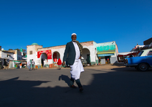 Muslim man passing in the market, Harari Region, Harar, Ethiopia