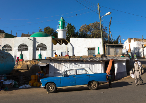 Old Peugeot 404 taxi in front of a mosque, Harari Region, Harar, Ethiopia