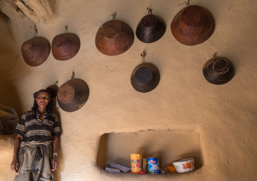 Woman inside her house decorated with leather baskets in a traditional Argoba stone houses village, Harari Region, Koremi, Ethiopia