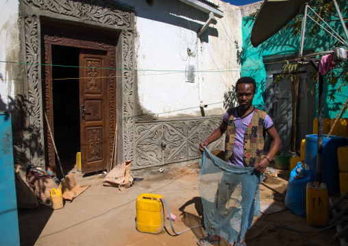 Ethiopian worker restoring an old harari house, Harari Region, Harar, Ethiopia