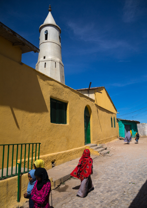 Women passing in the street in front of al-Jami mosque, Harari Region, Harar, Ethiopia