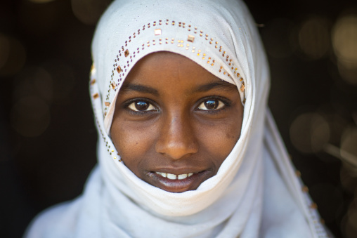 Portrait of a smiling Afar tribe girl with a white veil, Afar region, Afambo, Ethiopia