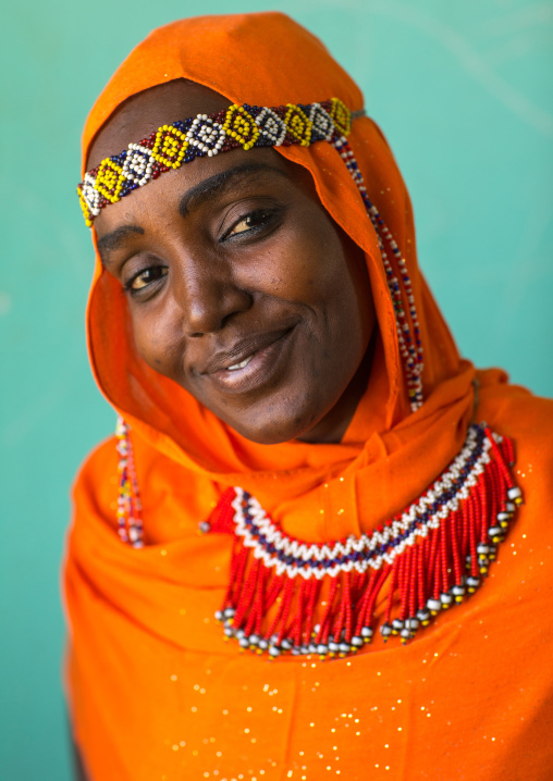 Portrait of an Afar tribe woman with an orange veil and a beaded headband, Afar region, Semera, Ethiopia