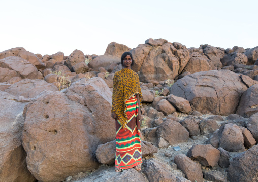 Afar tribe woman standing in a rocky area, Afar region, Assaita, Ethiopia