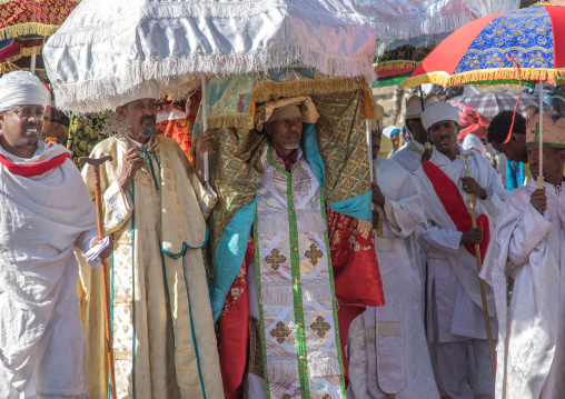 Ethiopian priests carrying some covered tabots on their heads during Timkat epiphany festival, Amhara region, Lalibela, Ethiopia