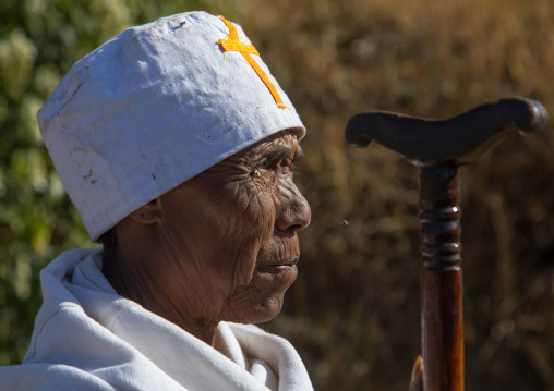 Ethiopian monk woman with her stick during Timkat epiphany festival, Amhara region, Lalibela, Ethiopia
