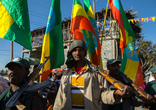 Policemen with weapons under ethiopian flags during Timkat epiphany festival, Amhara region, Lalibela, Ethiopia