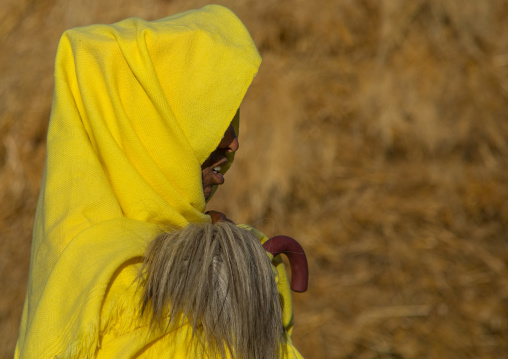 Portrait of an ethiopian monk woman in yellow shawl with a flyswatter, Amhara region, Lalibela, Ethiopia