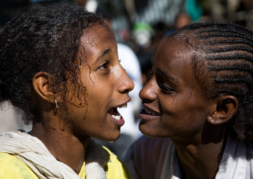 Wet ethiopian girls after taking the holy bath during Timkat epiphany festival, Amhara region, Lalibela, Ethiopia