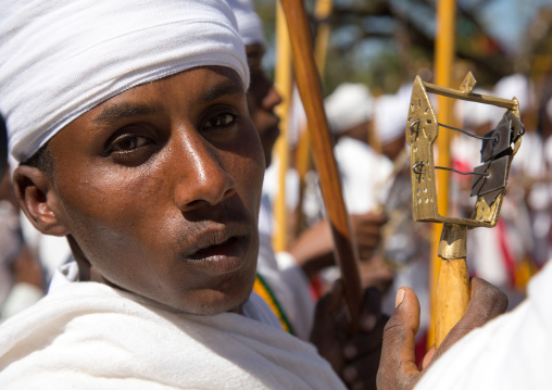 Ethiopian orthodox priest with a sistrum rattle celebrating the colorful Timkat epiphany festival, Amhara region, Lalibela, Ethiopia