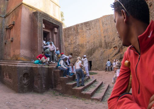 Tourists in the monolithic rock-cut church of st George, Amhara region, Lalibela, Ethiopia