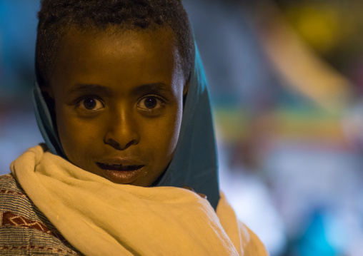 Young ethiopian girl during Timkat epiphany festival at night, Amhara region, Lalibela, Ethiopia