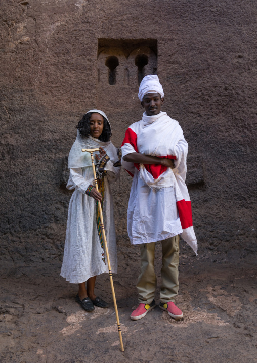 Orthodox ethiopian priest with his wife in a rock church, Amhara region, Lalibela, Ethiopia