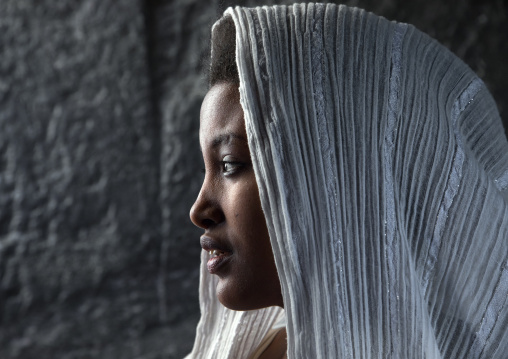 Pilgrim woman with a white shawl on her head during Timkat festival, Amhara region, Lalibela, Ethiopia