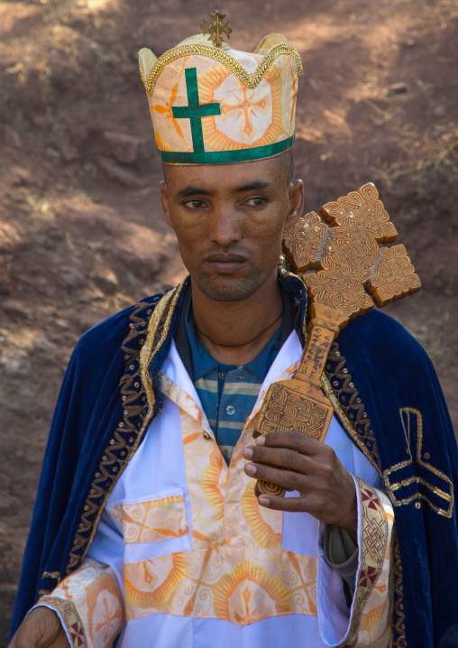 Monk of the ethiopian orthodox church with a wooden cross, Amhara region, Lalibela, Ethiopia