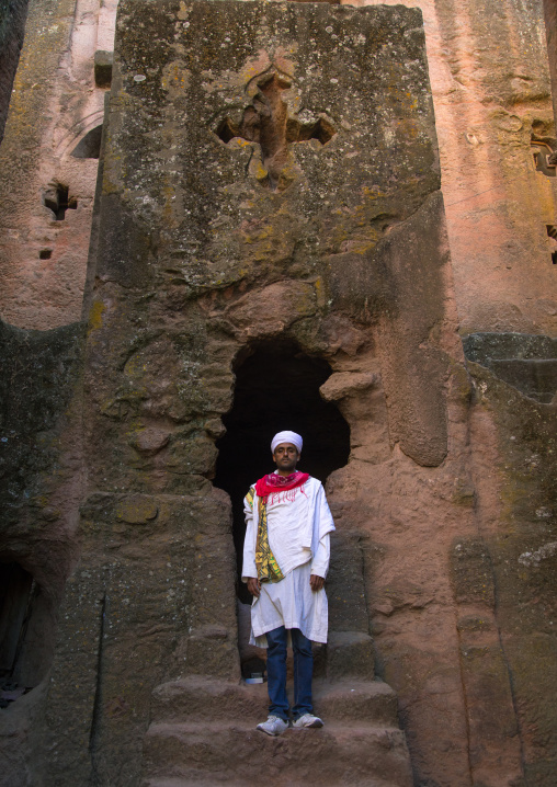 Orthodox priest standing in a rock church, Amhara region, Lalibela, Ethiopia