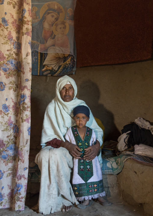 Portrait of an ethiopian monk woman with an orphan girl inside a house, Amhara region, Lalibela, Ethiopia
