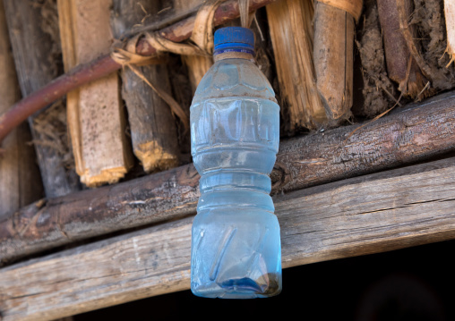Plastic bottle of holy water in Asheten mariam rock hewn church to bring luck and chase the bad spirits, Amhara region, Lalibela, Ethiopia