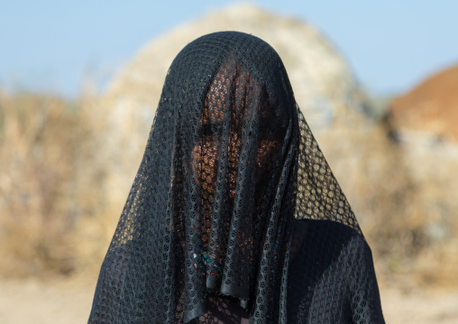 Portrait of an Afar tribe woman with her face covered with a veil to protect from the dust, Afar region, Chifra, Ethiopia