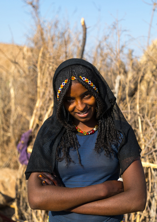 Portrait of a smiling Afar tribe girl with braided hair, Afar region, Chifra, Ethiopia