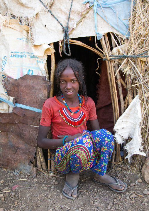 Portrait of an Afar tribe girl with braided hair in front of her hut, Afar region, Chifra, Ethiopia
