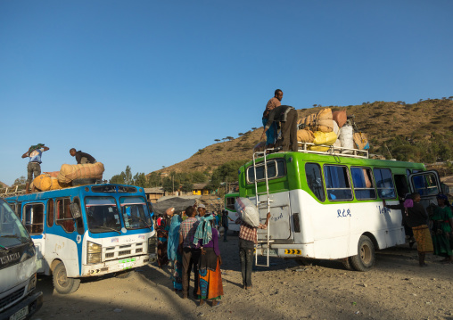People loading buses with bags at the end of the market, Amhara region, Senbete, Ethiopia
