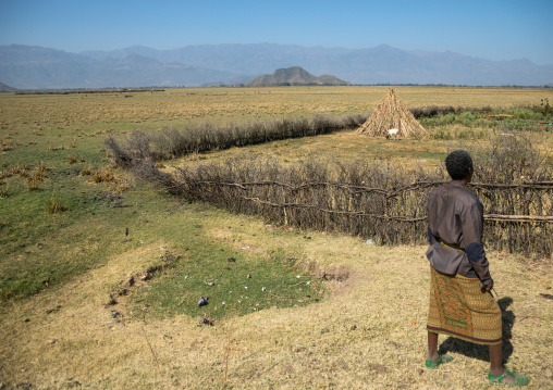 Artuma tribe man in front of a wood fence, Amhara region, Kemise, Ethiopia