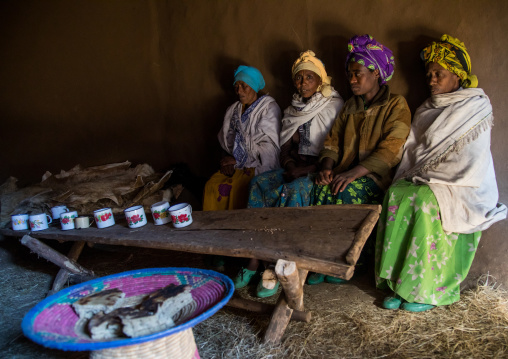 Ethiopian women from the highlands in a house to share a drink and eat bread, Amhara region, Debre Birhan, Ethiopia