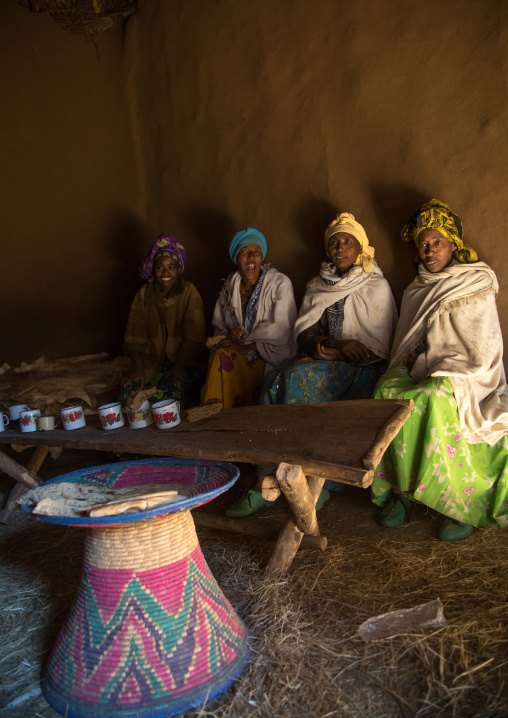Ethiopian women from the highlands in a house to share a drink and eat bread, Amhara region, Debre Birhan, Ethiopia