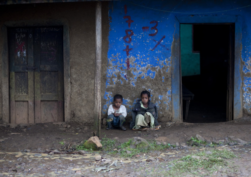 Kids sitting in front a ruined house, Ethiopia