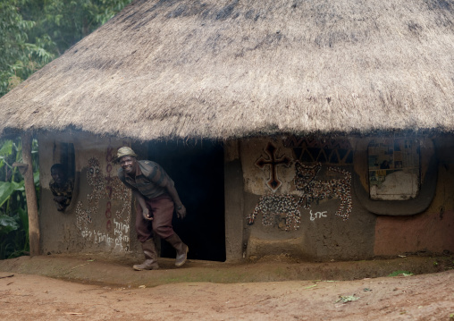 Benje man getting out of his house, Ethiopia