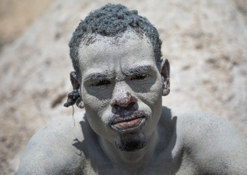 Borana tribe man covered with salt after diving in the volcano crater to collect salt, Oromia, El Sod, Ethiopia