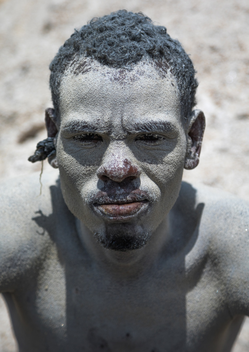 Borana tribe man covered with salt after diving in the volcano crater to collect salt, Oromia, El Sod, Ethiopia