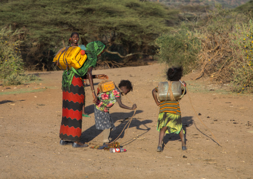 Borana tribe people carying jerricans filled with water, Oromia, Yabelo, Ethiopia