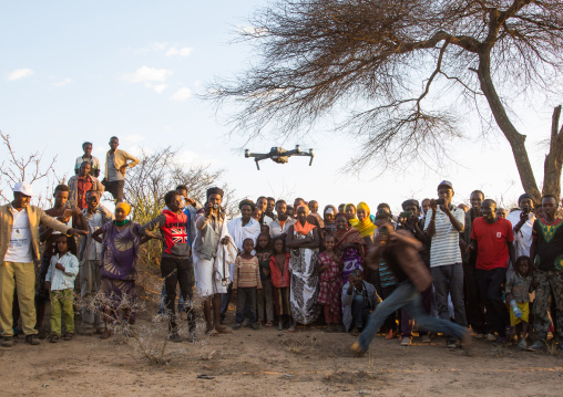 Borana people watching a mavic pro dji drone during the Gada system ceremony, Oromia, Yabelo, Ethiopia