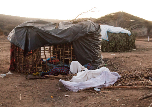 People sleeping wrapped in white clothes during the Gada system ceremony in Borana tribe, Oromia, Yabelo, Ethiopia