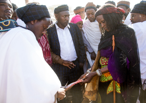 Kura Jarso sharing the genitals of a bull with his wife during the Gada system ceremony in Borana tribe, Oromia, Yabelo, Ethiopia