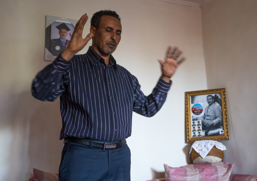 Pastor Mohamed Ousman Salih who converted from islam to christianity praying in his home, Addis Ababa region, Addis Ababa, Ethiopia