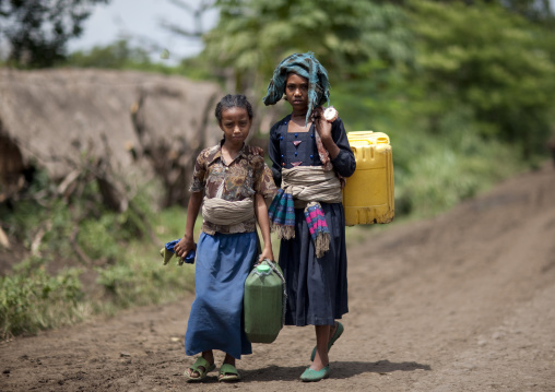 Girls carrying water in jerrycans, Ethiopia
