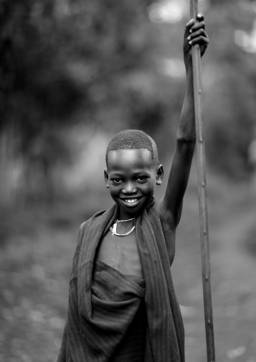 Menit boy holding a stick, Tum market, Omo valley, Ethiopia