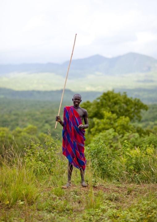 Suri man holding a stick, Tulgit, Omo valley, Ethiopia